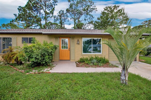 ranch-style home featuring a front yard