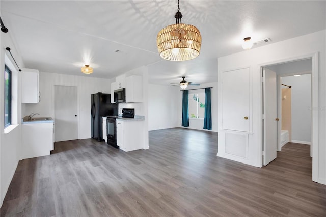 kitchen featuring white cabinets, sink, hardwood / wood-style floors, and black appliances