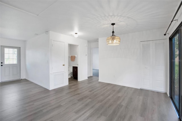 unfurnished room with wood-type flooring