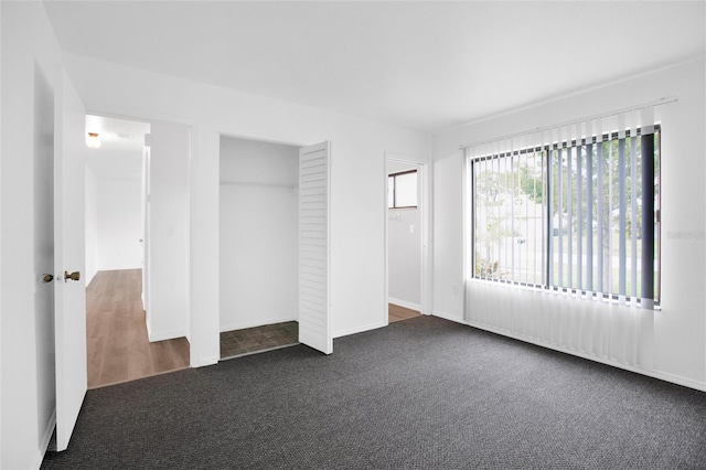 empty room with dark colored carpet