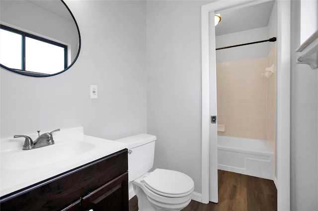 full bathroom with vanity, shower / washtub combination, hardwood / wood-style floors, and toilet