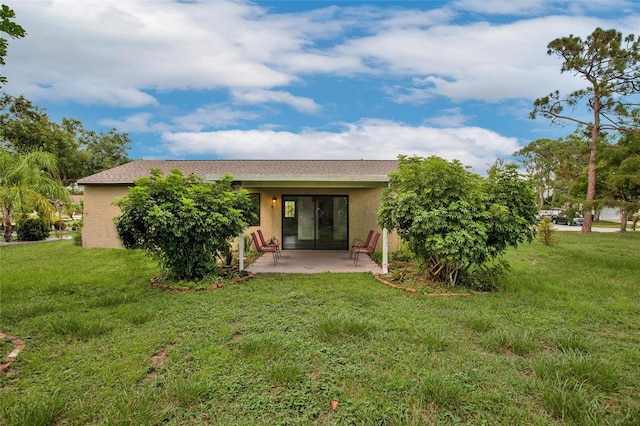 back of house featuring a yard and a patio area