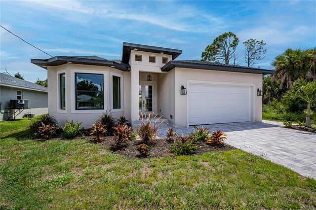 view of front of house with a garage and a front yard