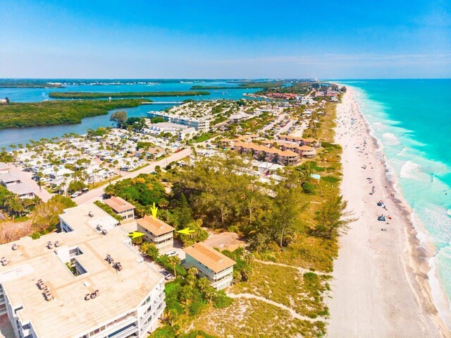 bird's eye view featuring a water view and a beach view