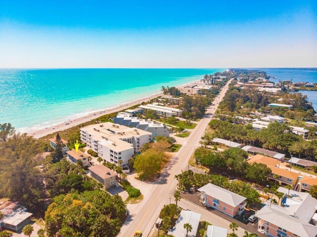 bird's eye view featuring a water view and a beach view