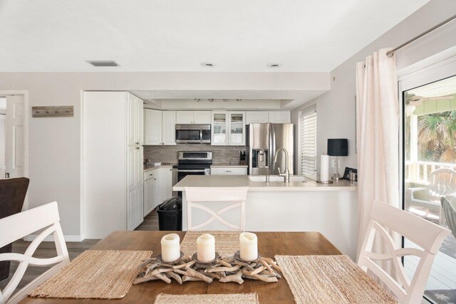 dining space with sink and dark hardwood / wood-style floors