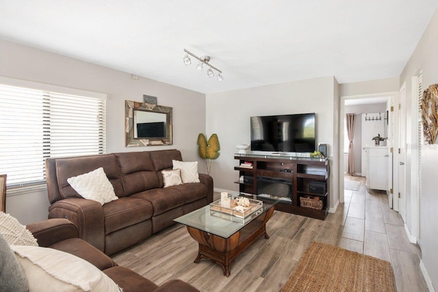 living room with track lighting and light wood-type flooring