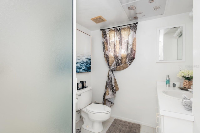 bathroom with vanity, toilet, and tile patterned flooring