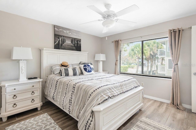 bedroom with ceiling fan and hardwood / wood-style floors