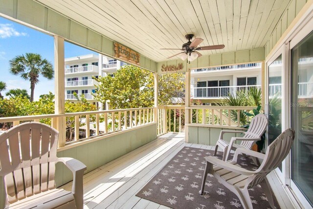 sunroom / solarium featuring ceiling fan and wood ceiling