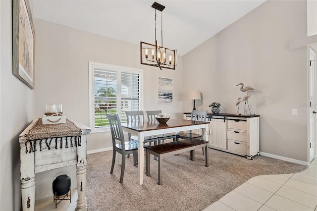 tiled dining space featuring vaulted ceiling and a chandelier