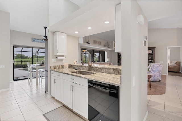 kitchen with sink, white cabinetry, light stone countertops, light tile patterned flooring, and dishwasher