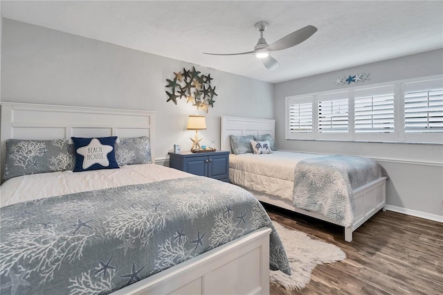 bedroom featuring dark hardwood / wood-style floors, multiple windows, and ceiling fan