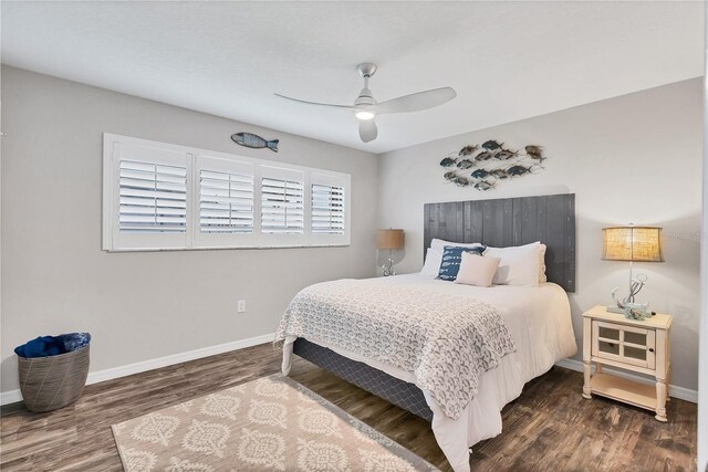 bedroom featuring multiple windows, ceiling fan, and dark hardwood / wood-style floors