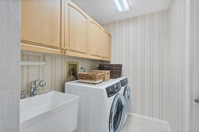 laundry room featuring cabinets, washer and dryer, sink, and light tile patterned floors