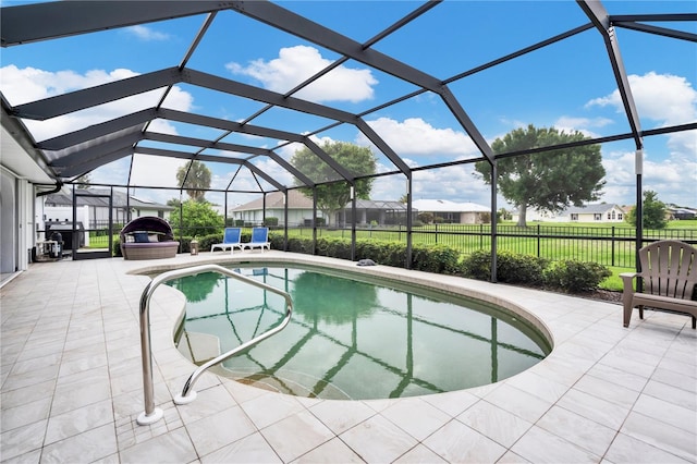 view of swimming pool featuring a lanai and a patio