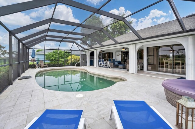 view of swimming pool featuring a lanai, a patio, and ceiling fan