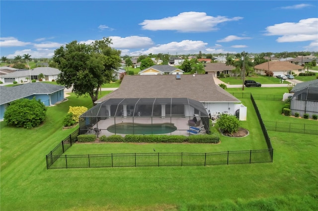 rear view of property with a lawn, a fenced in pool, and a lanai