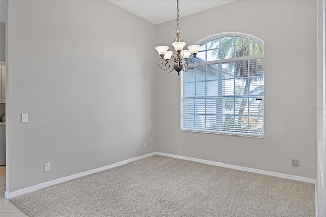 unfurnished room with washer / dryer, light carpet, baseboards, and an inviting chandelier