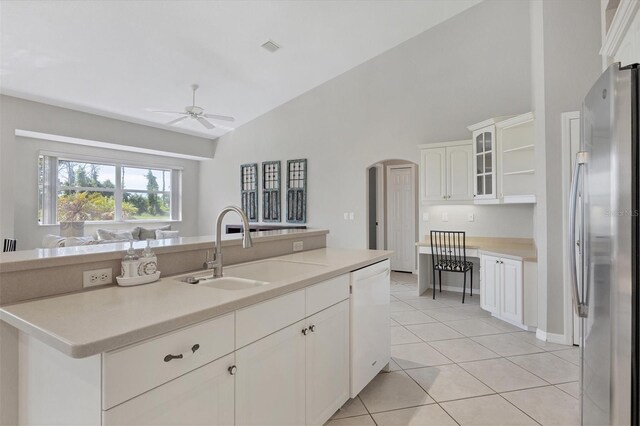 kitchen featuring stainless steel fridge, white cabinetry, light tile patterned flooring, lofted ceiling, and ceiling fan