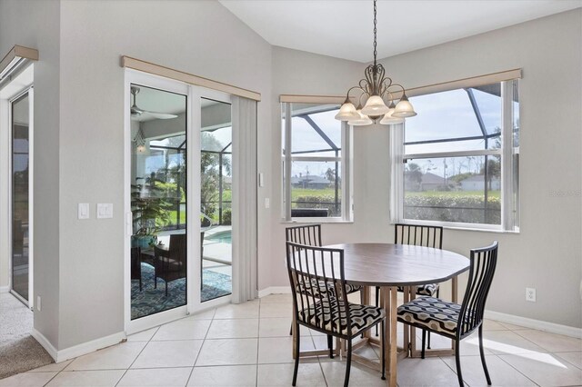 dining area with light tile patterned floors, a chandelier, and a wealth of natural light