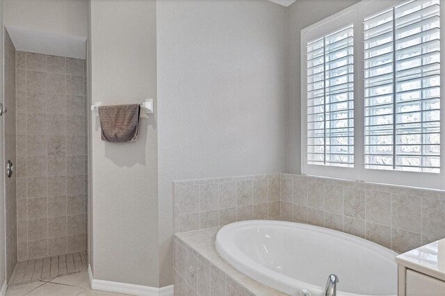 bathroom featuring shower with separate bathtub and tile patterned floors