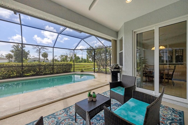 view of swimming pool featuring a patio and a lanai