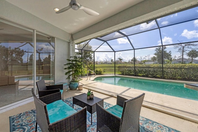 pool featuring a lanai, a patio area, and ceiling fan