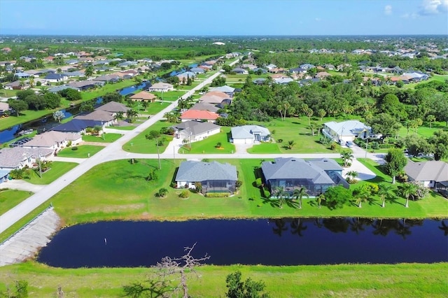 birds eye view of property featuring a water view and a residential view