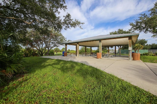 surrounding community with a yard and a patio