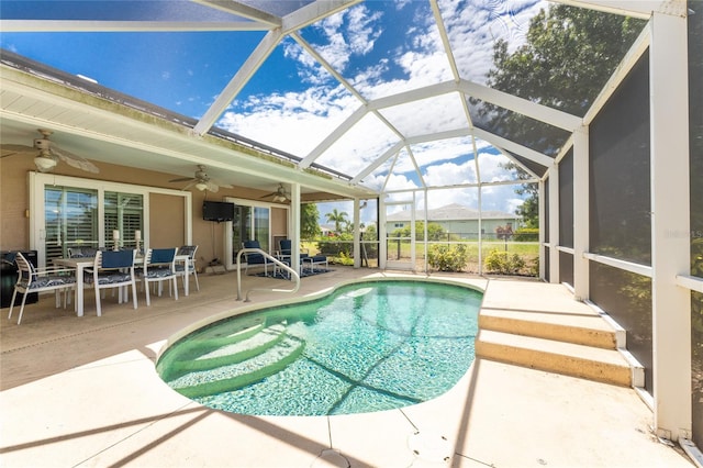 view of pool with a lanai, a patio area, and ceiling fan