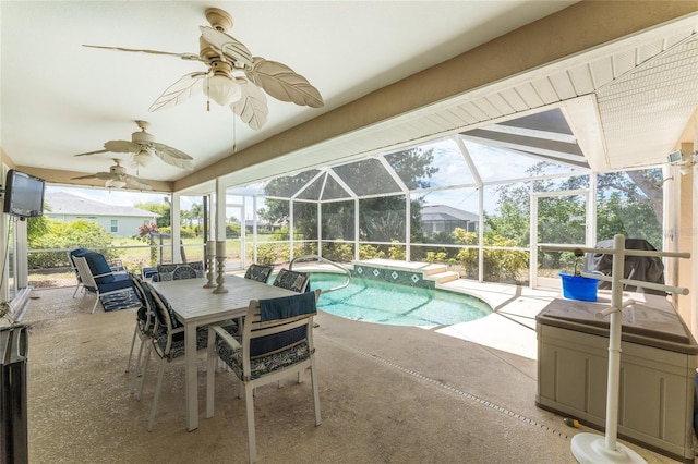 view of pool with a patio, ceiling fan, and glass enclosure