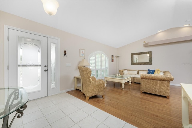 tiled entryway with vaulted ceiling