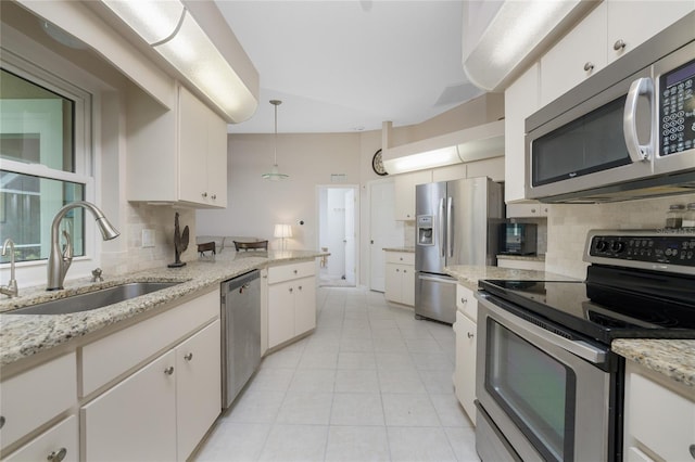 kitchen featuring white cabinetry, stainless steel appliances, tasteful backsplash, and sink