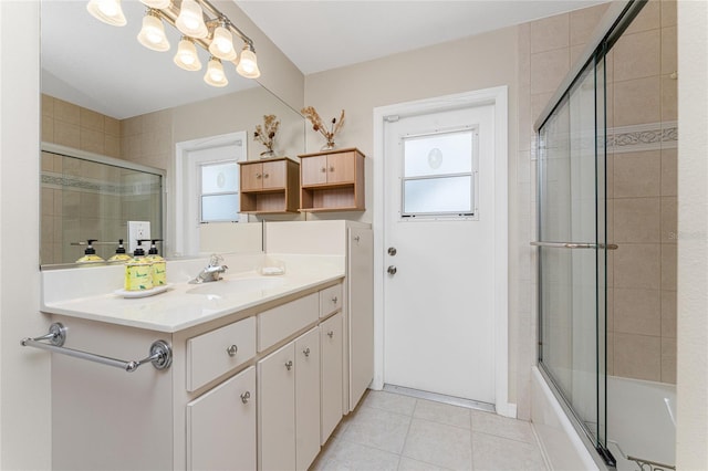 bathroom with vanity, enclosed tub / shower combo, and tile patterned floors