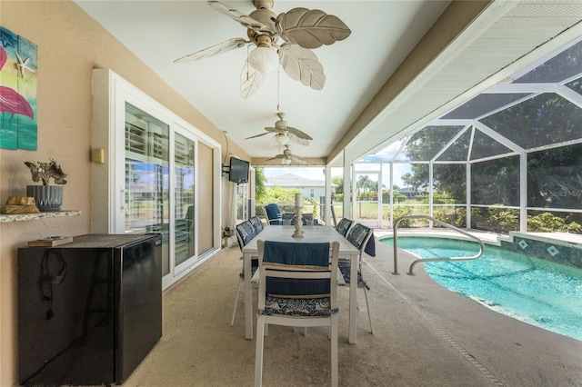 view of pool featuring a patio, ceiling fan, and glass enclosure