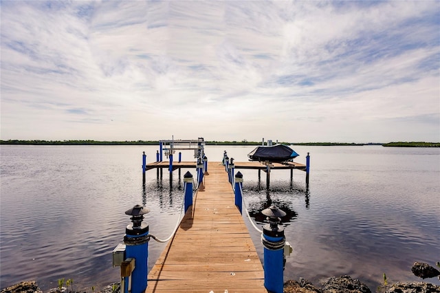 dock area with a water view and boat lift