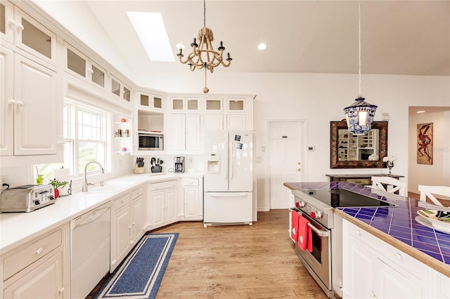 kitchen with sink, stainless steel appliances, light hardwood / wood-style floors, and white cabinets