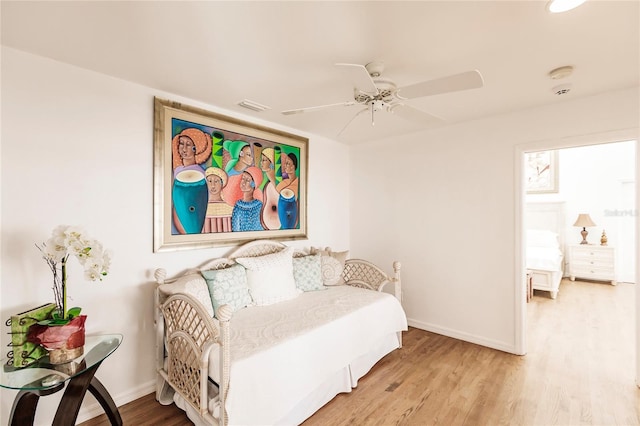 bedroom with ceiling fan and light hardwood / wood-style floors