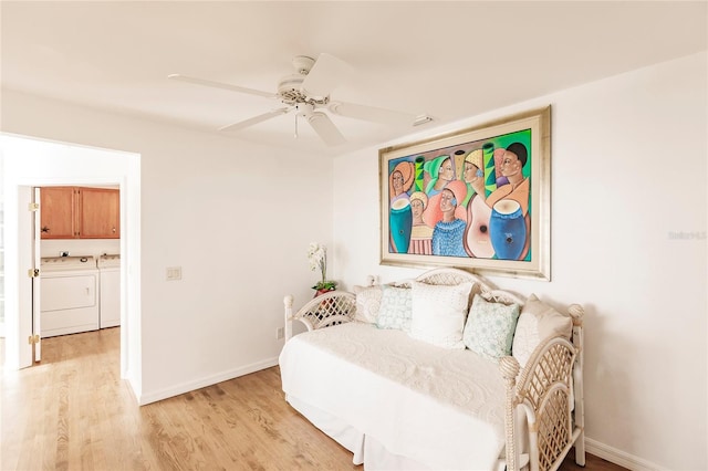 bedroom with light hardwood / wood-style floors, separate washer and dryer, and ceiling fan