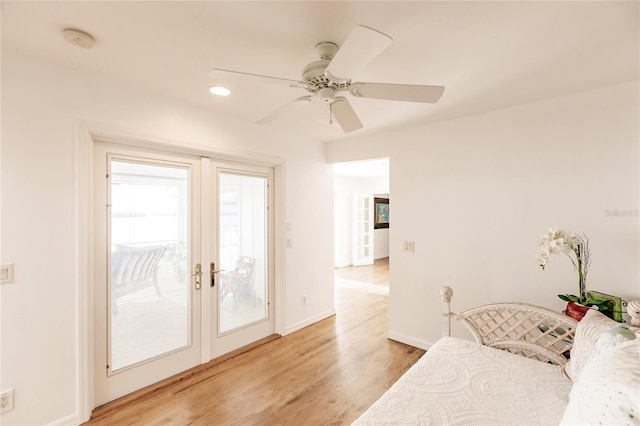 bedroom featuring french doors, access to outside, light wood-type flooring, and ceiling fan