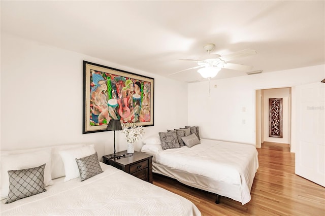 bedroom with ceiling fan and hardwood / wood-style floors