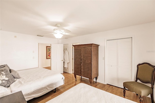 bedroom featuring light hardwood / wood-style flooring, a closet, and ceiling fan