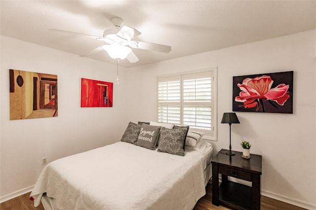 bedroom with ceiling fan and dark wood-type flooring