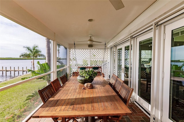 exterior space featuring a water view and ceiling fan