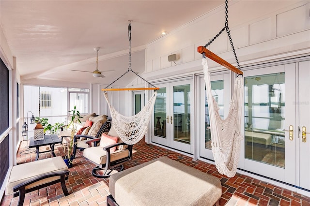 sunroom / solarium featuring french doors and ceiling fan