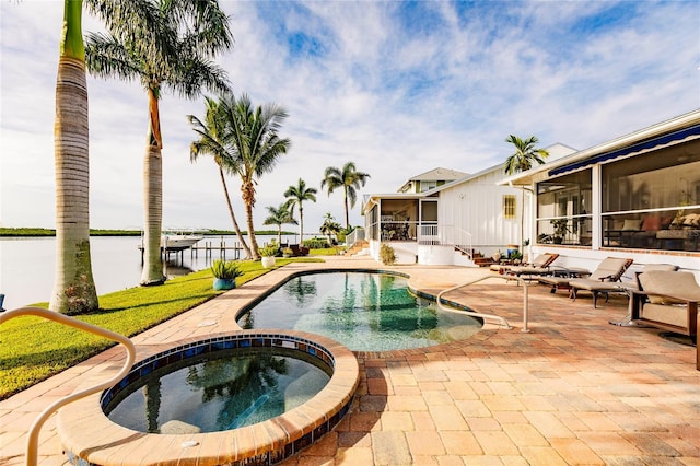 view of swimming pool with an in ground hot tub and a patio