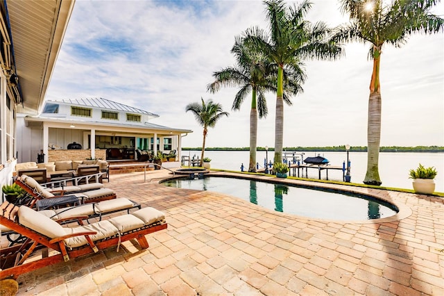 view of pool featuring a dock, a patio, a water view, and an outdoor living space