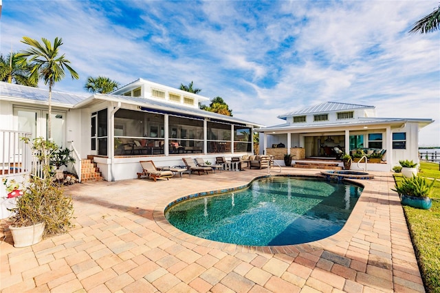 view of pool with a patio area and a sunroom