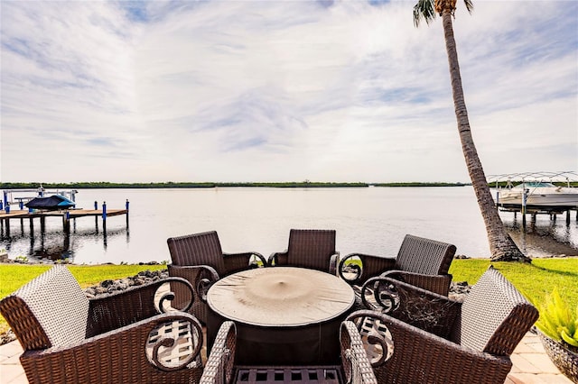 view of patio / terrace with a boat dock and a water view